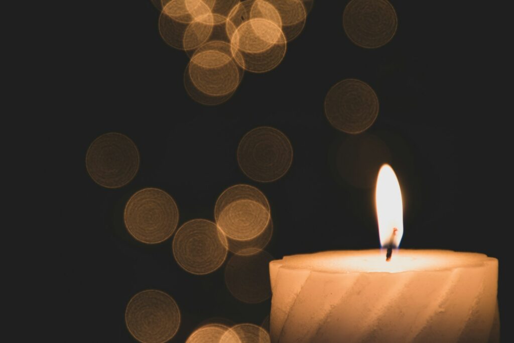 bokeh lights photography of lighted candle